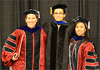 Three people wearing academic robes